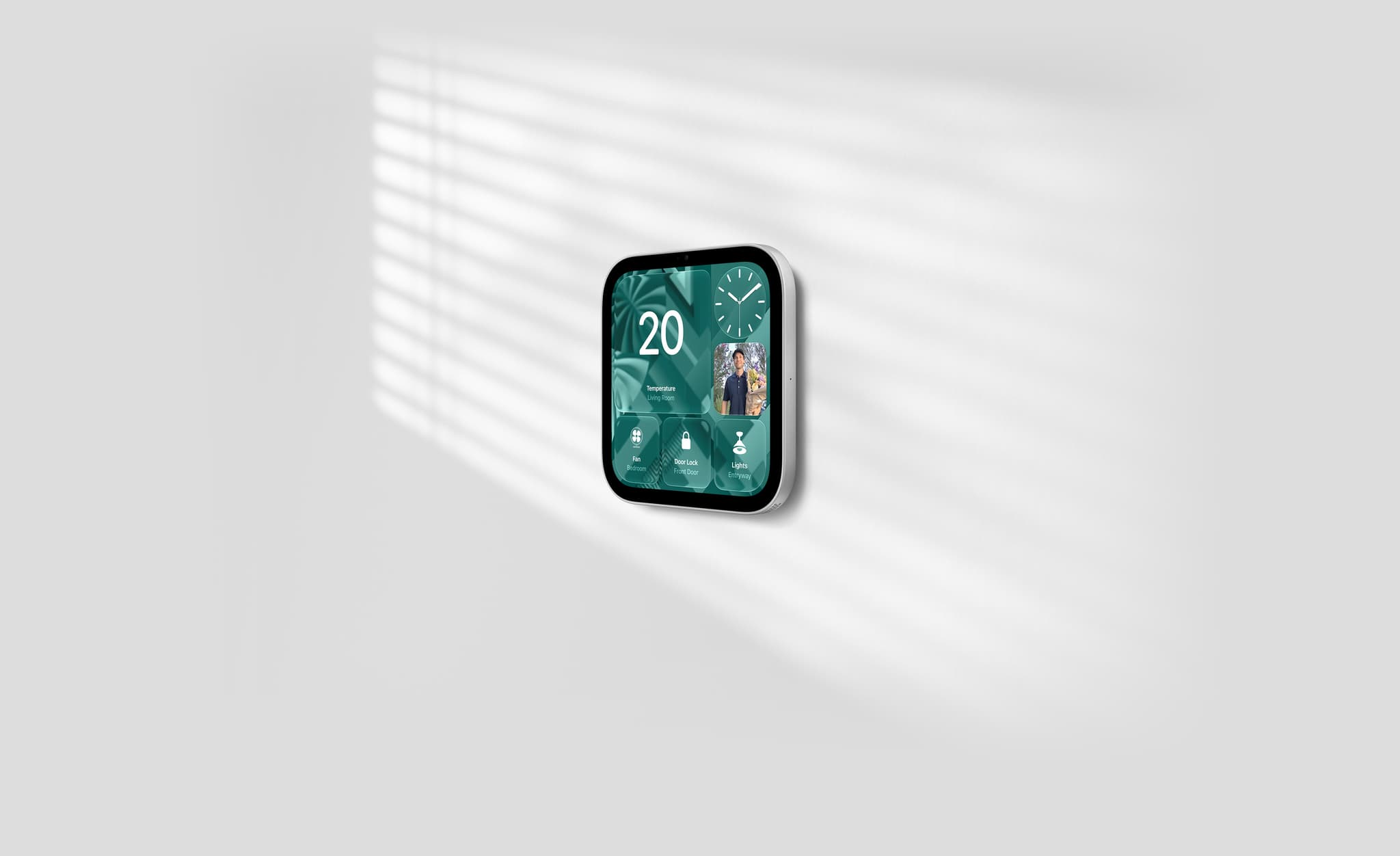 Apple HomeView (Wall Mounted) in silver on a plain wall, showing temperature, a front door camera feed and smart home controls